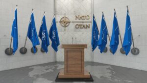 NATO OTAN Concept with NATO Flag in a Row with a Empty Wooden Wall. Press Conference in Government Building