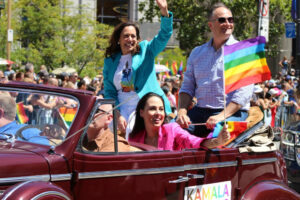 Vicepresident Kamala Harris och hennes man Douglas Emhoff åker i en öppen bil och vinkar åt publiken i San Francisco Pride. Foto: Vita huset